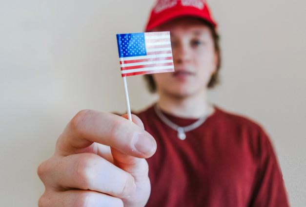 Young man holding small American flag