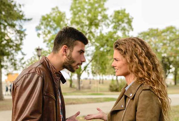 Man and woman having disagreement in outdoor setting