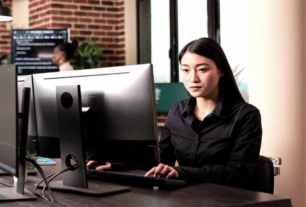 Young woman working in an office on a computer