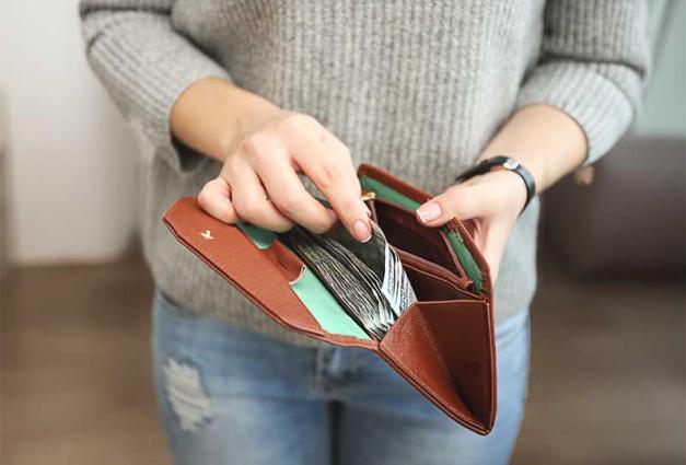 Woman taking money out of a wallet