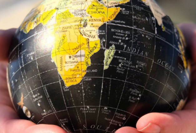 Image of hands holding a globe.