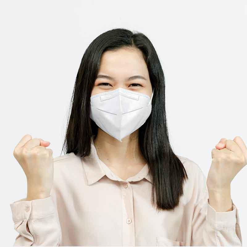 Asian woman wearing mask and holding up both fists