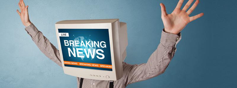 Image of a man with a computer monitor for a head, screen reads breaking news