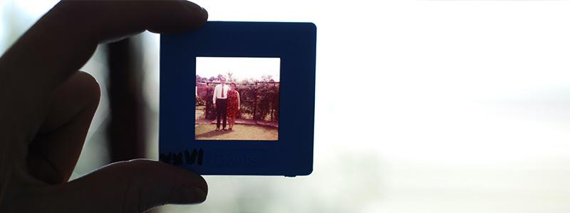 Person holding photo slide up against light