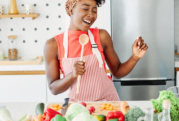 Young Black woman preparing vegetables