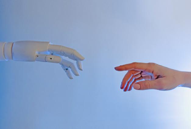 Human hand reaching out to robot hand