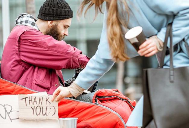 Young woman giving money to jobless man