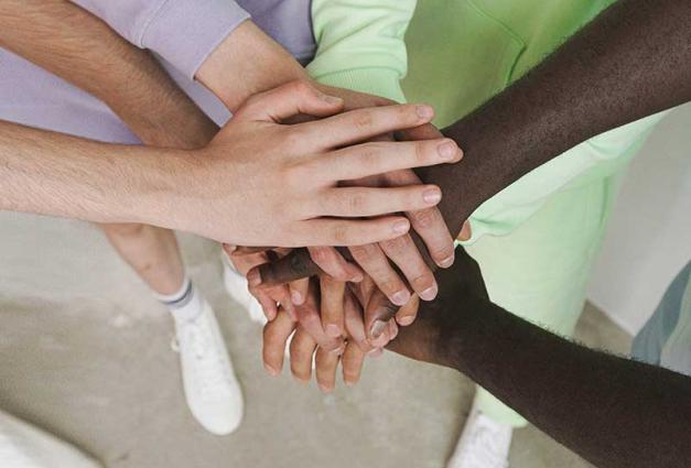 Group of People with Their Hands Together