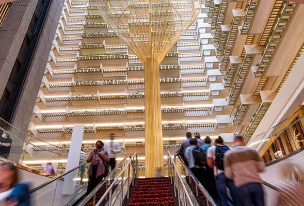 People on an escalator in a hotel lobby