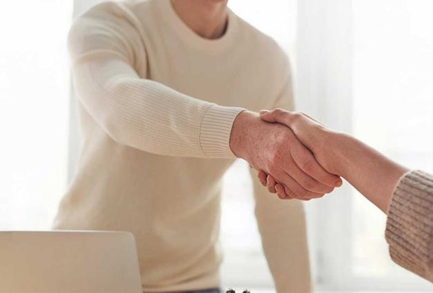 Man shaking hands with woman