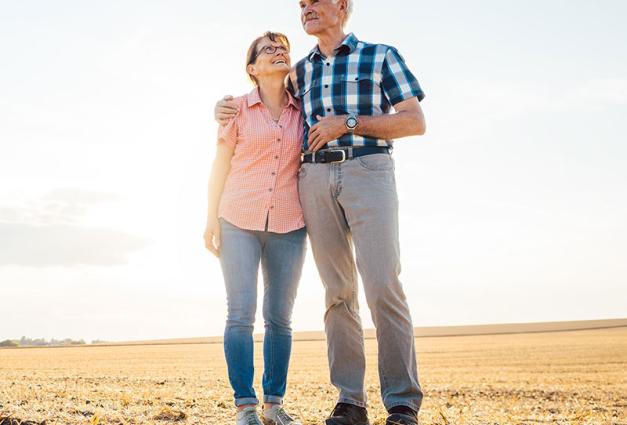 Senior couple standing in an open field