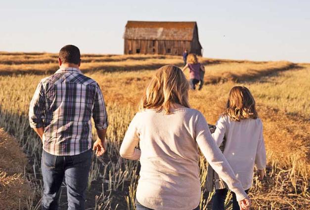 Family walking through field