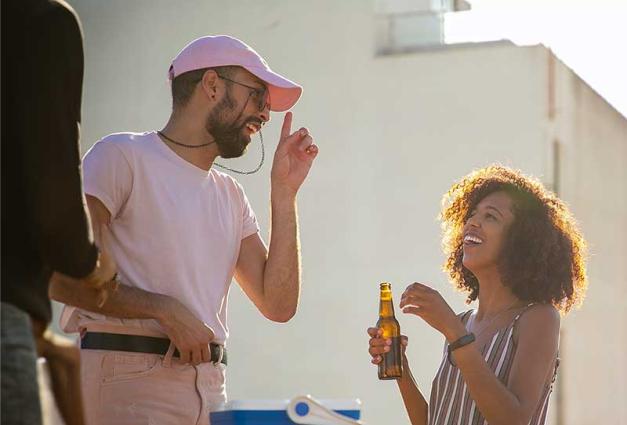 Man and woman laughing at outdoor party