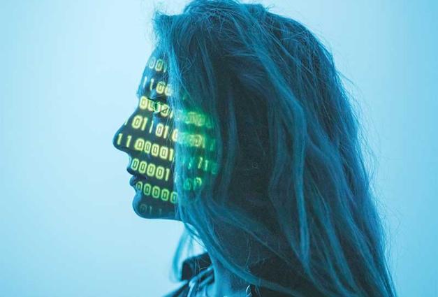 Woman with computer code projected onto her face
