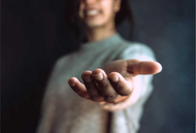 Young woman extending her hand
