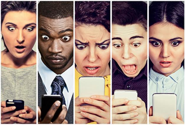 Several diverse faces look into cell phones with expressions of shock and surprise