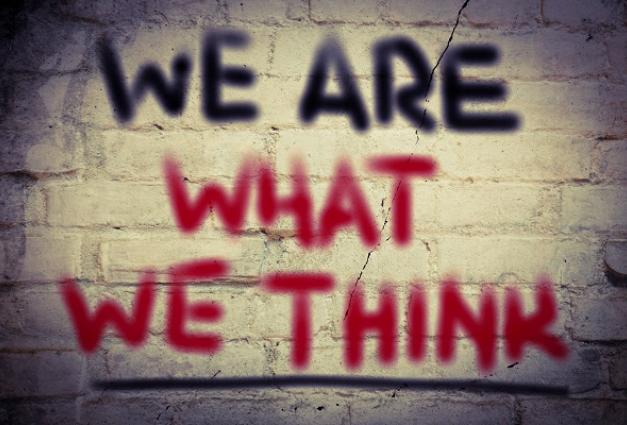 "We Are What We Think" written in graffiti on a brick background