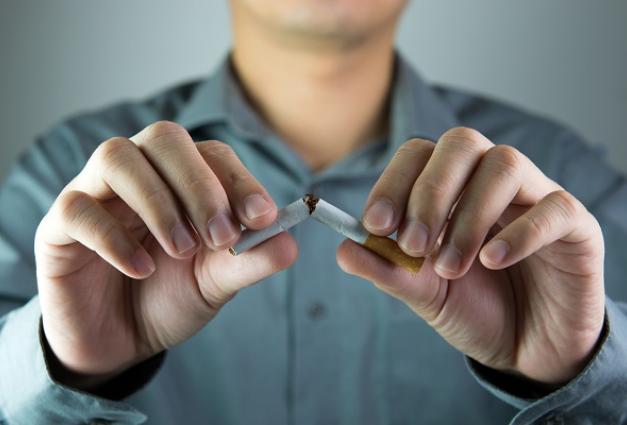 Image of a man snapping a cigarette in half