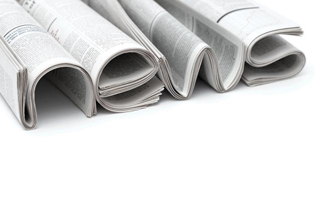 Image of newspapers shaped to spell the word News