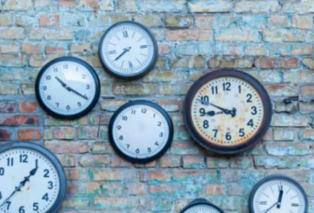 An image showing multiple clocks on a wall.