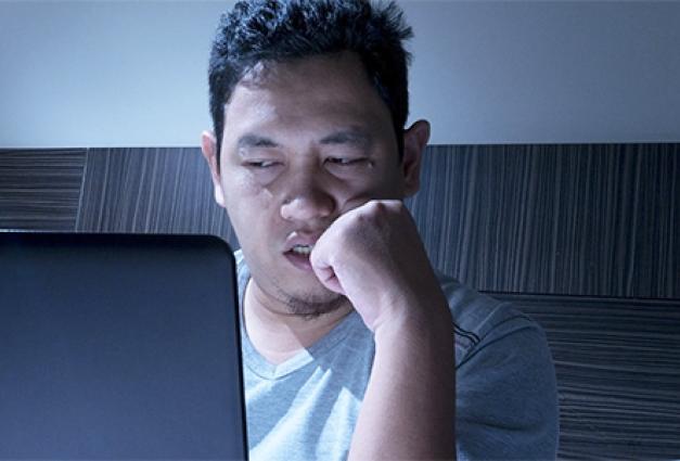 Man in bed alone with laptop