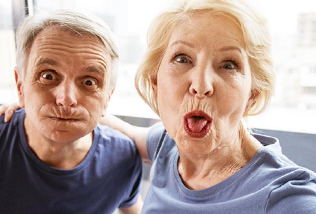 Older couple joking and making faces 