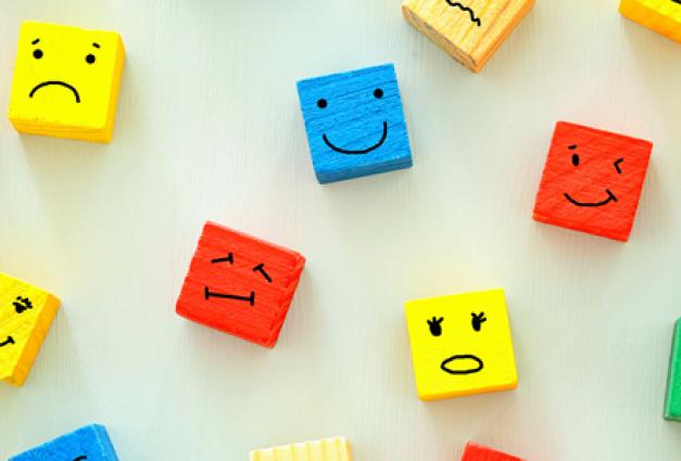 Different emotions drawn on colorful wooden blocks  