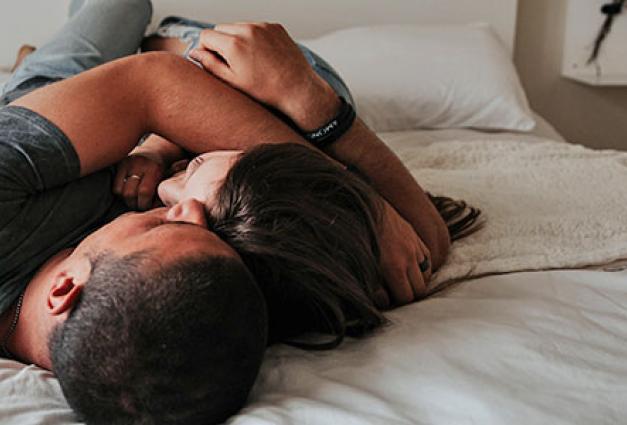 Couple embracing on bed