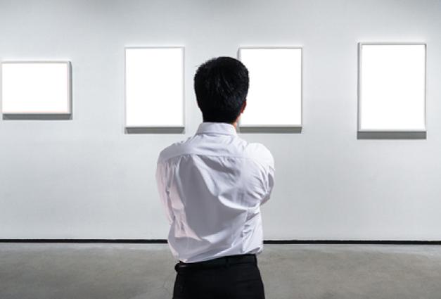 businessman standing in front of wall of art