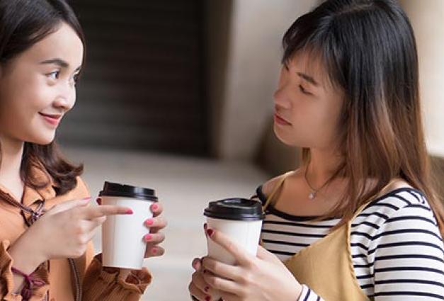 two friendly woman drinking coffee 