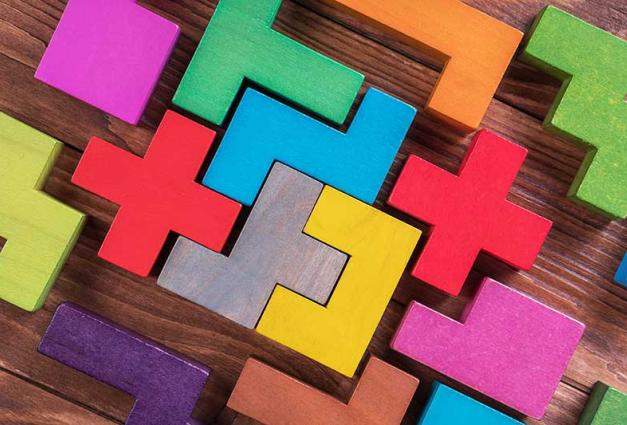 The concept of logical thinking. Geometric shapes on a wooden background.