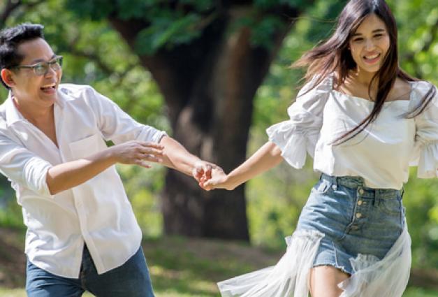 asian couple in love running in park having happiness and joy