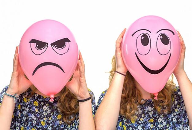 image of two women with balloon faces - one happy one angry