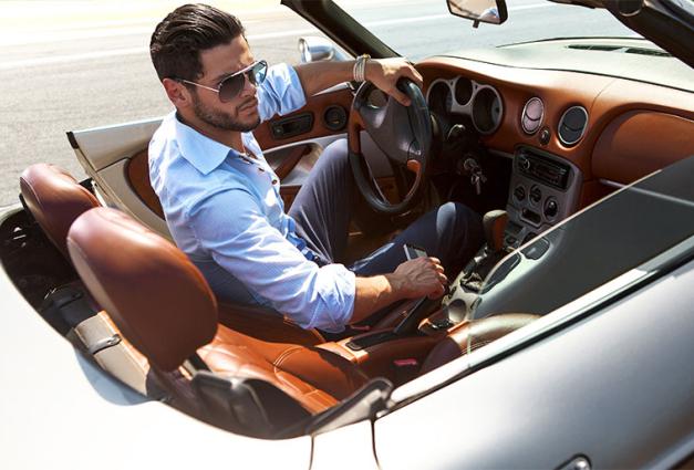 Image of well-dressed man sitting in a luxury automobile