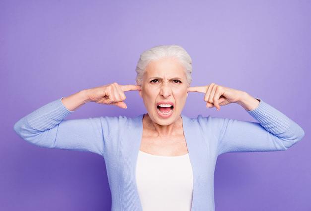 Image of woman screaming with her fingers in her ears