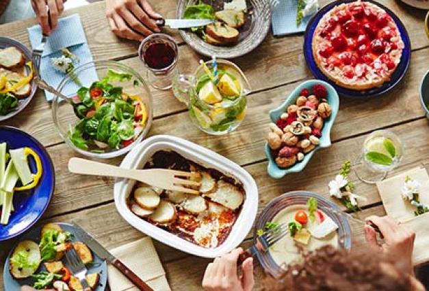 Image of crowded table with many dishes of food on it