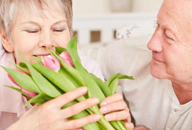 Senior woman gets flowers from husband