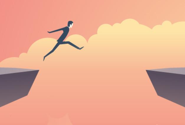Businessman jumping over chasm
