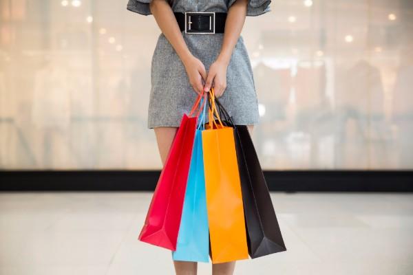Image of woman holding colorful shopping bags